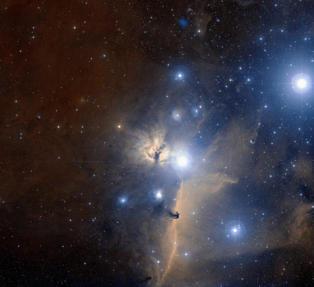 This is a visible light wide-field view of part of Orion's belt. This is the region of sky around the Flame Nebula. The bright blue spots are glowing gas clouds full of hot young stars.