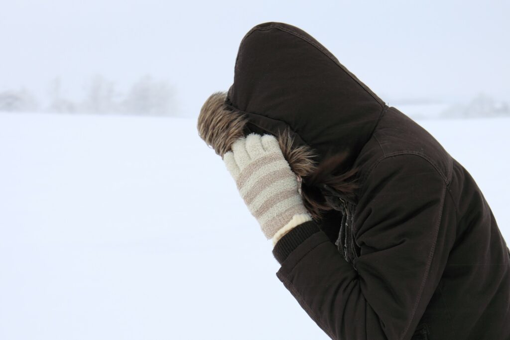 someone wearing a hood in the snow