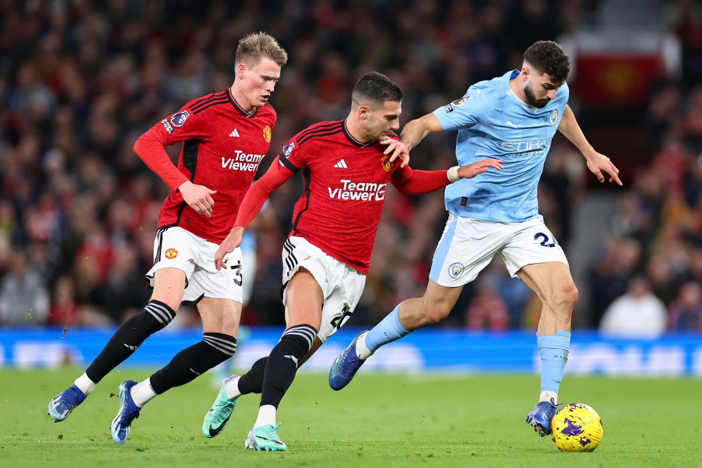 Manchester United and Manchester City players compete for the ball during the Manchester derby