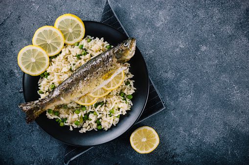 Roasted trout seasoned with spices and lemon juice with rice