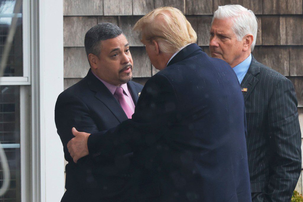 New York Police Department Commissioner Edward Caban greets former President Donald Trump as he arrives for the wake for slain Officer Jonathan Diller at the Massapequa Funeral Home
