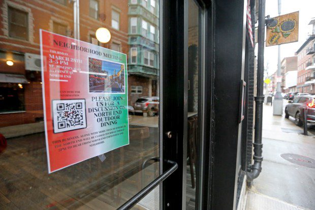 A sign tells passersby of the meeting at Monica's as restaurant owners and workers hold a meeting on outside dining at St. Joseph's Hall on March 28. (Staff Photo By Stuart Cahill/Boston Herald)