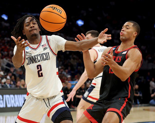 UConn Huskies guard Tristen Newton, left, bobbles the ball in front of San Diego State Aztecs forward Jaedon LeDee during the first half Thursday in Boston. (Matt Stone/Boston Herald)