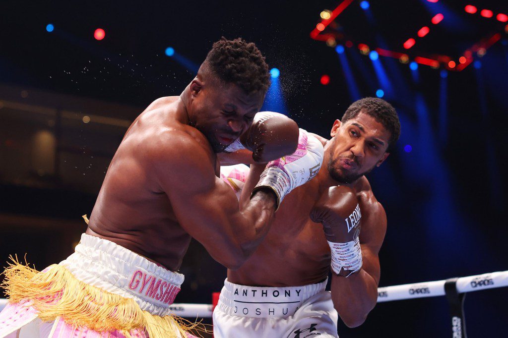 Anthony Joshua punches Francis Ngannou during the Heavyweight fight between Anthony Joshua and Francis Ngannou on the Knockout Chaos boxing card at the Kingdom Arena on March 08, 2024 in Riyadh, Saudi Arabia