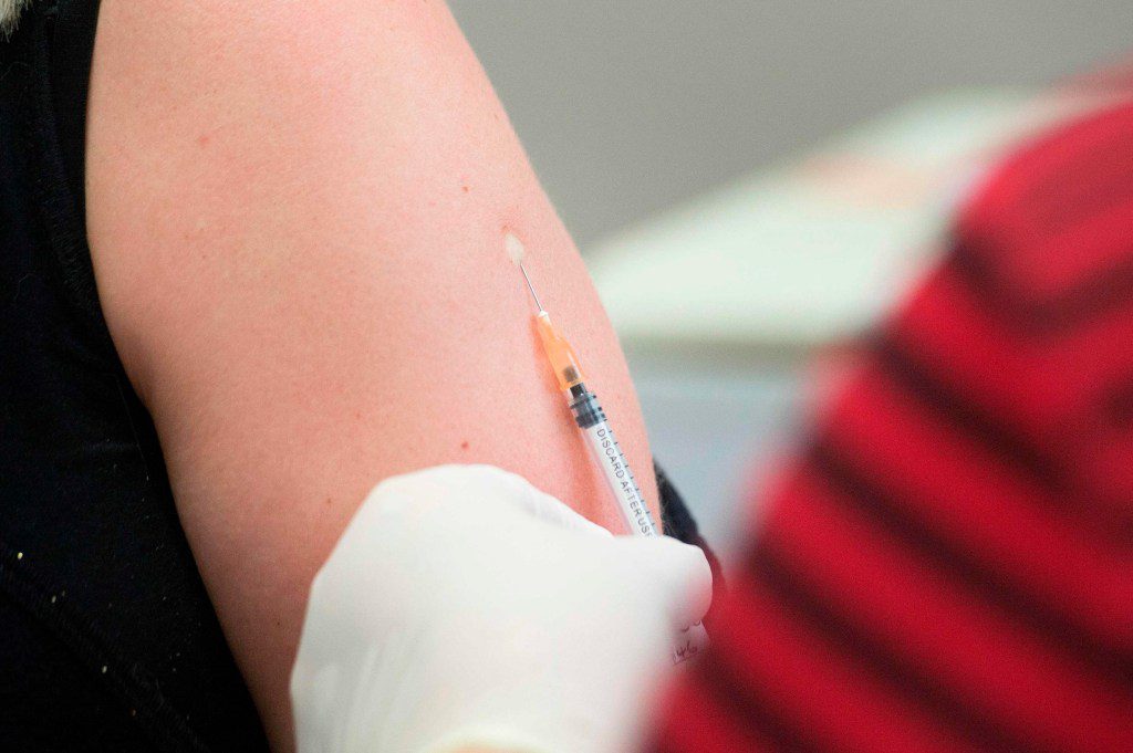 (FILES) In this file photo taken on May 04, 2020 a volunteer is injected with a syringe containing either the vaccine or a placebo, at the start of a clinical trial being set up by TASK, a clinical research organisation based in Cape Town, to see whether the Bacillus Calmette-Guerin (BCG) vaccine, which is given to babies in the country to protect them against tuberculosis, helps limit the damage caused by COVID-19, at a Hospital in Cape Town. - Orders for vaccines against diseases such as measles have declined since a national emergency was declared in the United States because of the coronavirus pandemic, the US Centers for Disease Control and Prevention said May 8, 2020. (Photo by RODGER BOSCH / AFP) (Photo by RODGER BOSCH/AFP via Getty Images)
