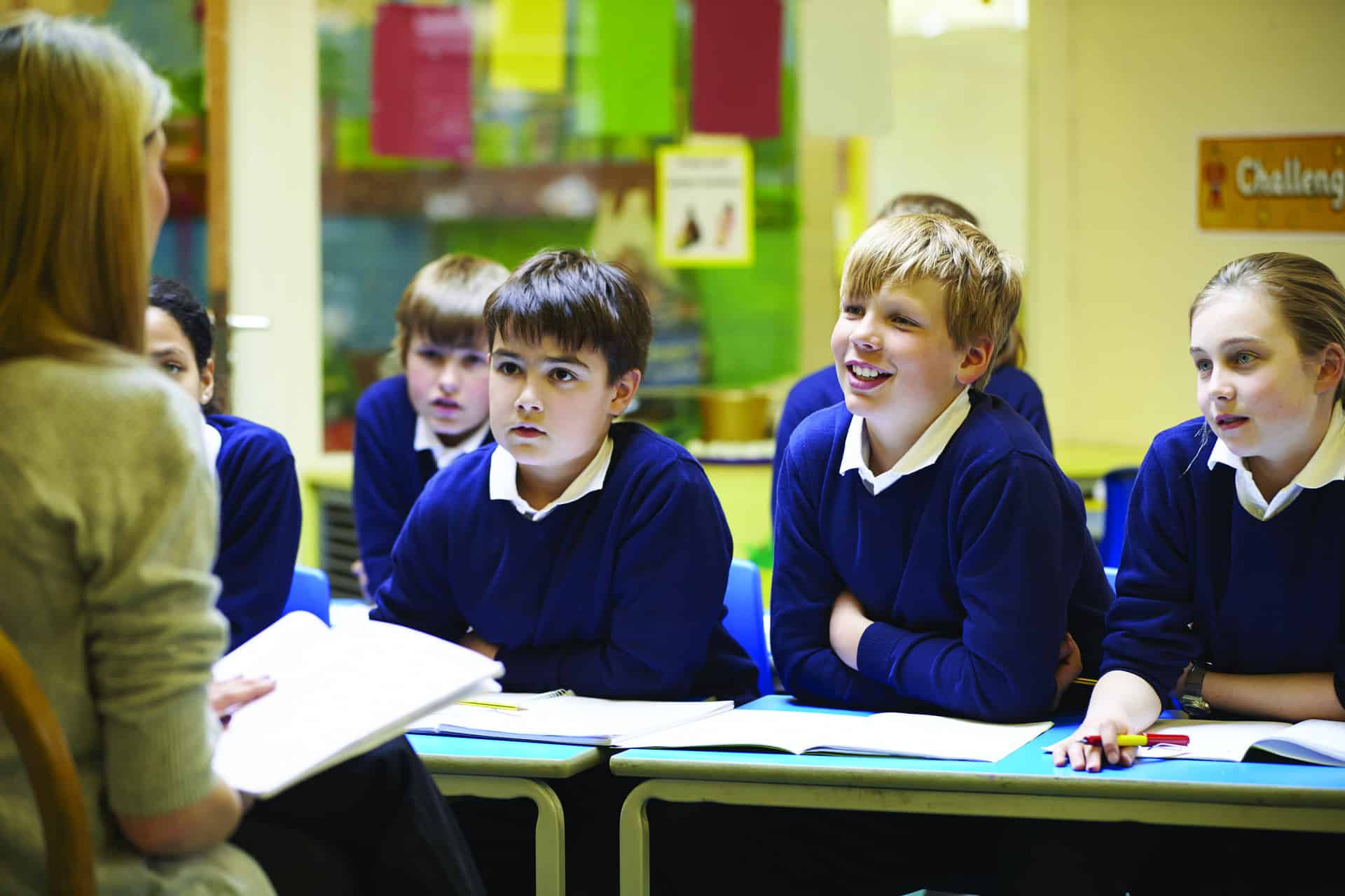 Children in classroom listening to teacher