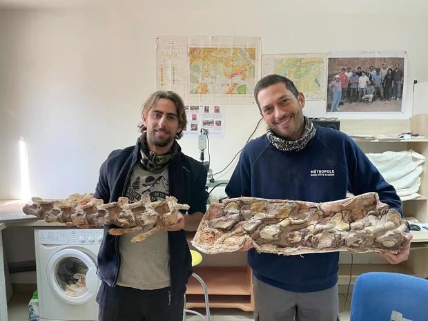 Damien Boschetto (left) holding some of the dinosaur bones he found