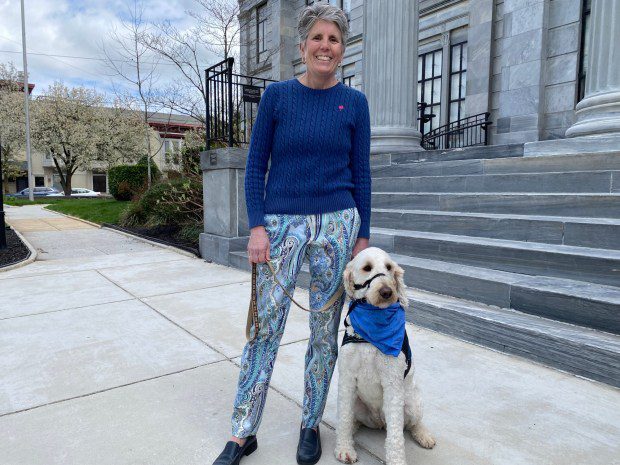 Nutmeg, a Goldendoodle comfort dog with the Montgomery Child Advocacy Project, and her handler, Mary J. Anders, attended the "Wear Blue on the Steps" for Child Abuse Prevention Month event on April 5, 2024. (Photo by Carl Hessler Jr. - MediaNews Group)