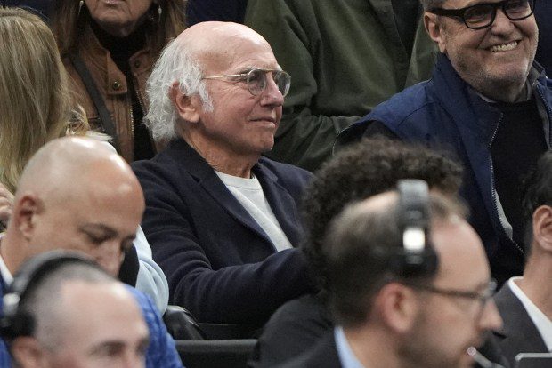 Actor Larry David watches from the stands as UConn and Illinois warms up prior to the first half of the Elite 8 college basketball game in the men's NCAA Tournament, Saturday. (AP Photo/Michael Dwyer)