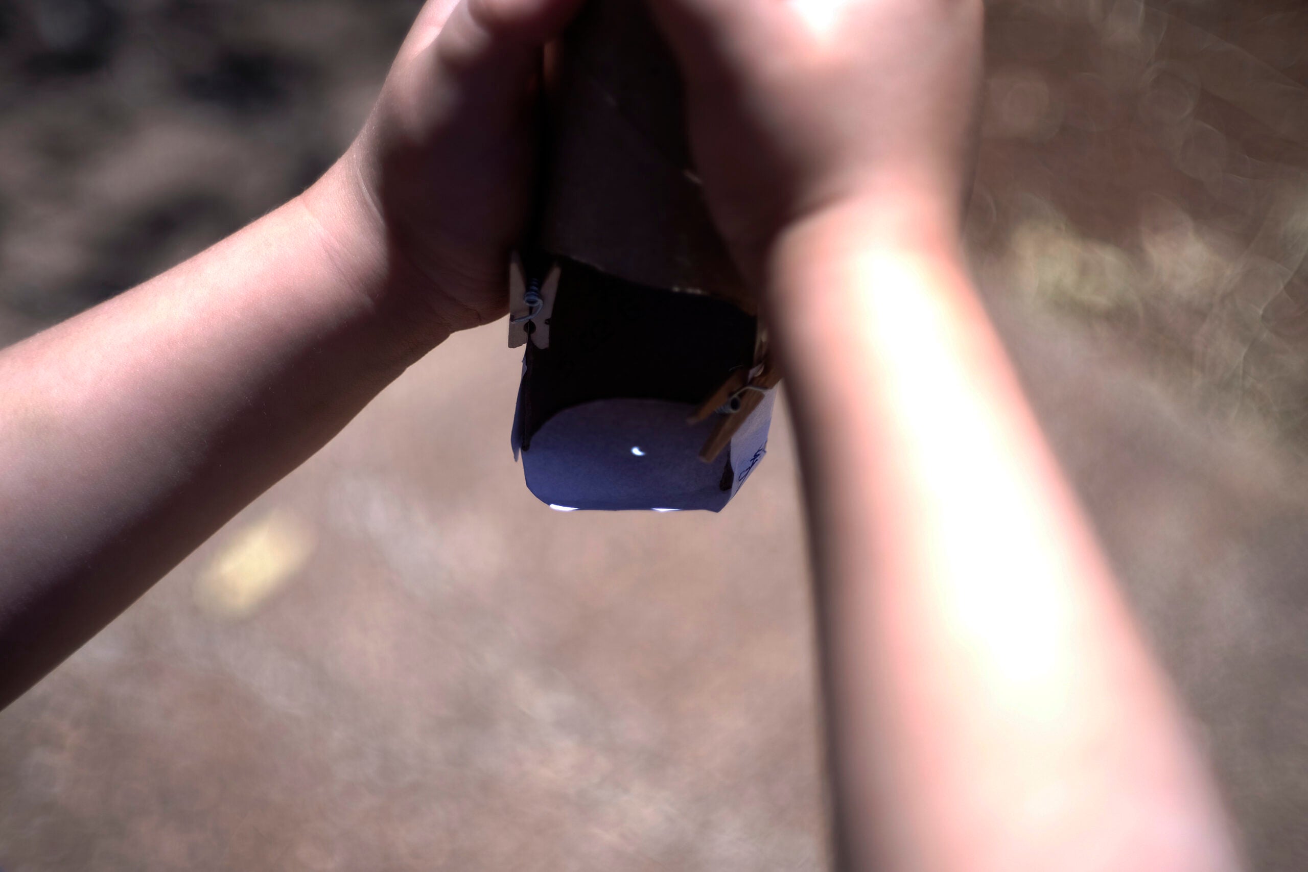 child's hand with the eclipse