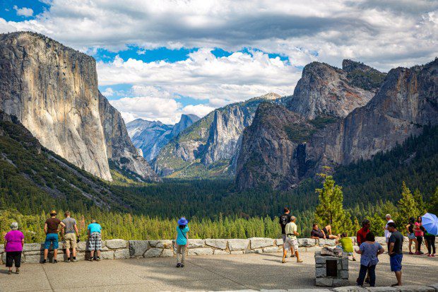 Tourists stop to gaze at the spectacular Yosemite Valley from the national park's Tunnel View lookout. Yosemite National Park will offer free admission on Saturday, April 20. (Photo by Getty Images)