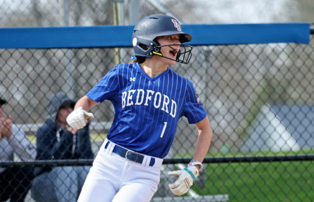 Bedford's Addi Poulter celebrates after she scored as Triton takes on Bedford in softball action on Friday. Host Bedford captured a 2-0 win. (Staff Photo/Stuart Cahill/Boston Herald)