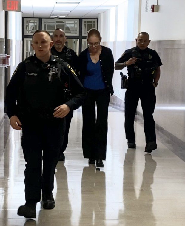 Jennifer Parker is escorted by deputy sheriffs from a Montgomery County courtroom on April 22, 2024, to begin serving prison term for leaving the scene after fatally striking a pedestrian in Whitemarsh. (Photo by Carl Hessler Jr. - MediaNews Group)