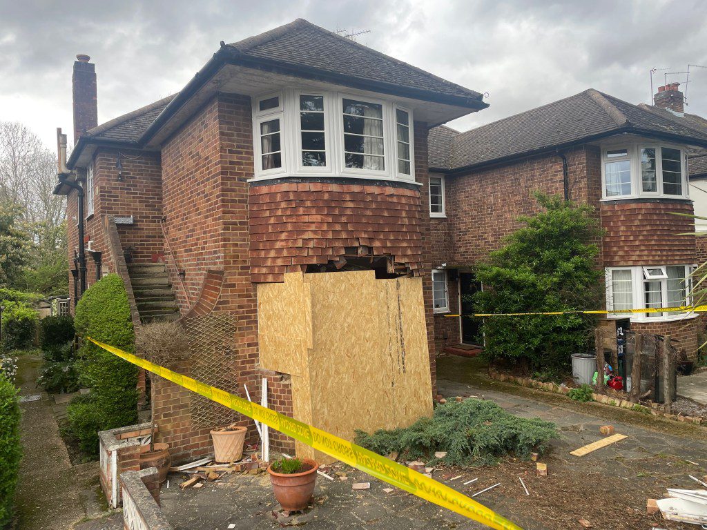 A house damaged after a car crashed into it in London.  