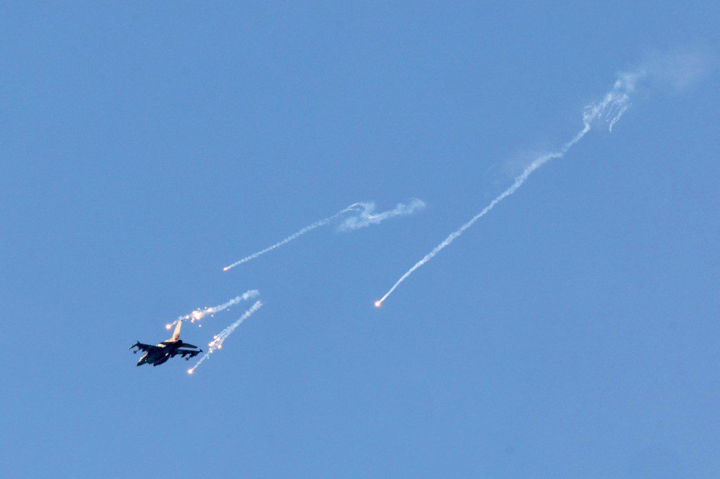 This picture taken from Israel's southern border with the Gaza Strip shows an Israeli jet fighter launching flares over the besieged Palestinian territory on March 21, 2024, amid the ongoing conflict between Israel and the militant group Hamas. (Photo by JACK GUEZ / AFP) (Photo by JACK GUEZ/AFP via Getty Images)