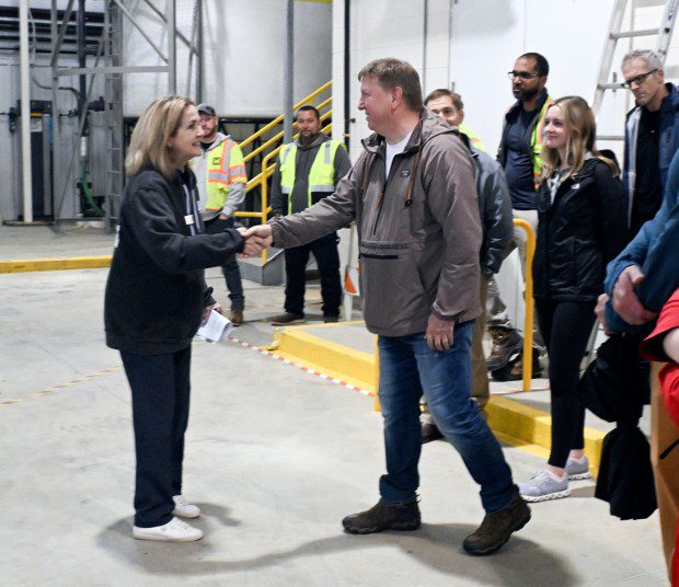 U.S. Rep. Madeline Dean greets Andy Graham, a neighbor of the Crossley Farm Superfund site in Hereford Township, whose property includes the discharge area of treated water. (BILL UHRICH - READING EAGLE)